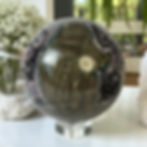 Amethyst Geode Sphere on a table.