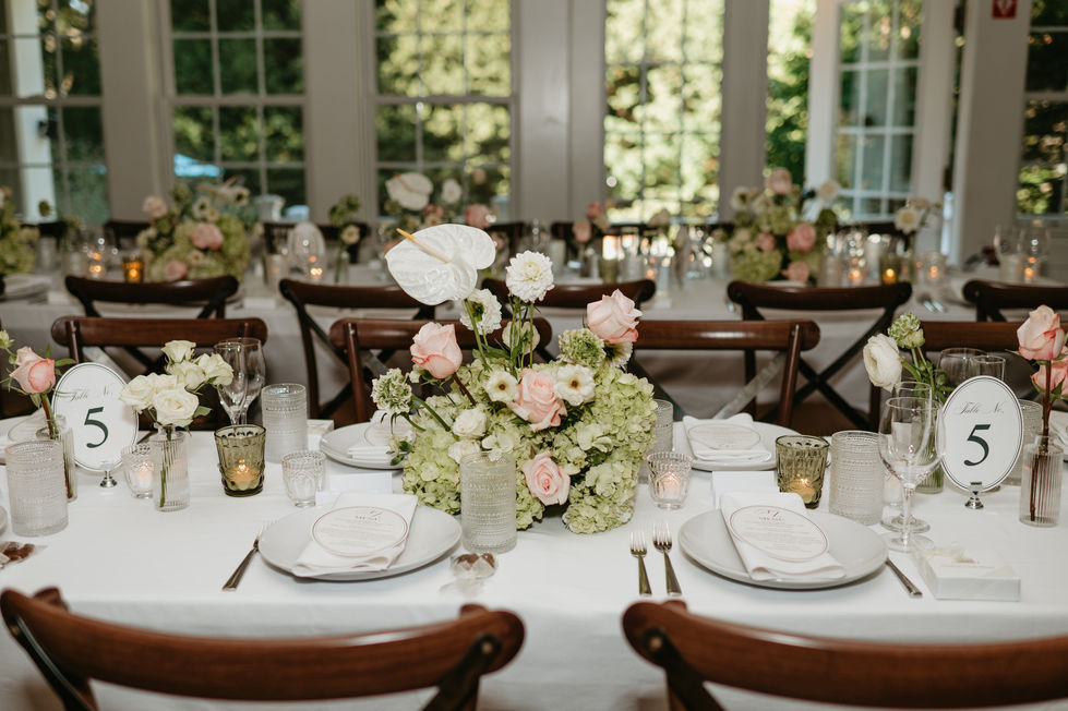 Elegant table setting with floral centerpieces and white linens.