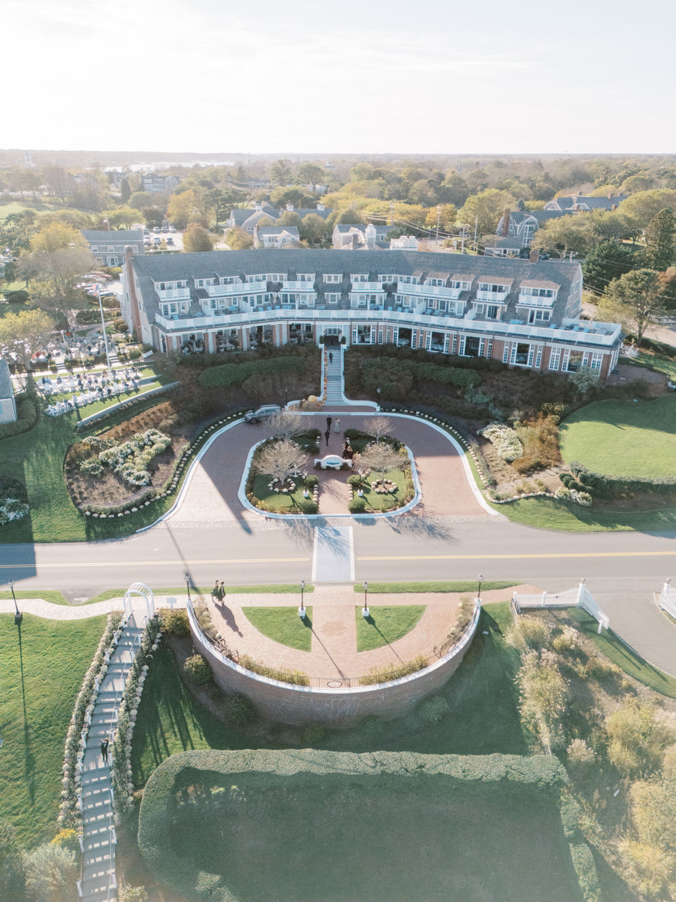 Aerial view of a large building with gardens.