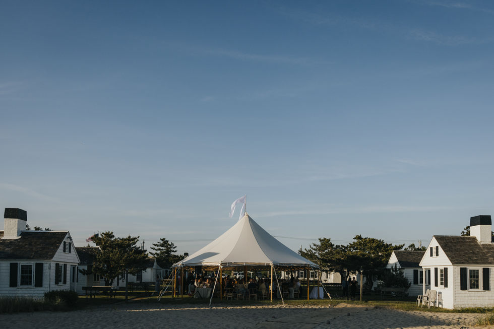 Tent on a beach with clear blue sky.