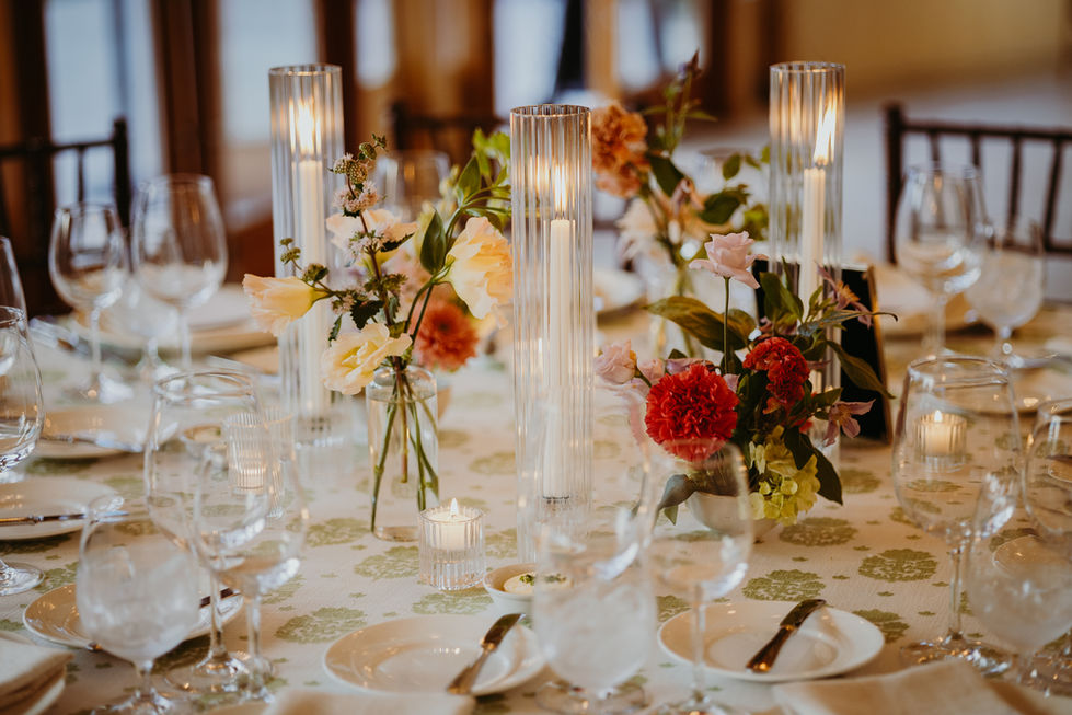 Elegant table setting with flowers and tall candles.