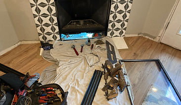 Right in the middle of fireplace maintenance. glass on the right. all components pulled out and lined up on a canvas mat to protect the floor.
