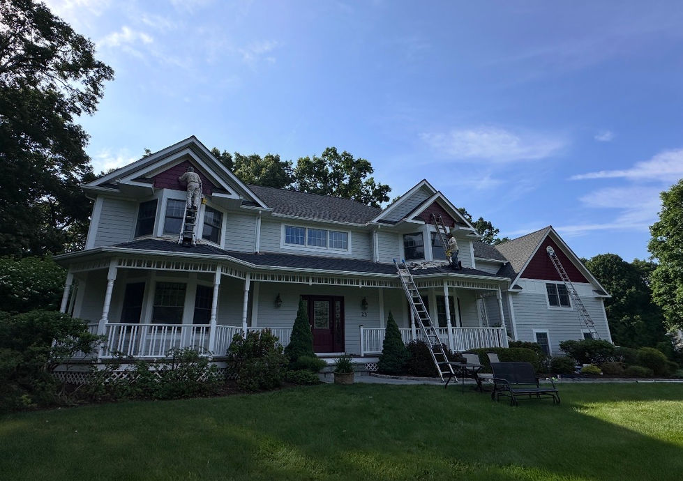 Exterior of a Katonah, NY home before repainting, showing faded paint and areas prepared for carpentry repairs and exterior restoration.