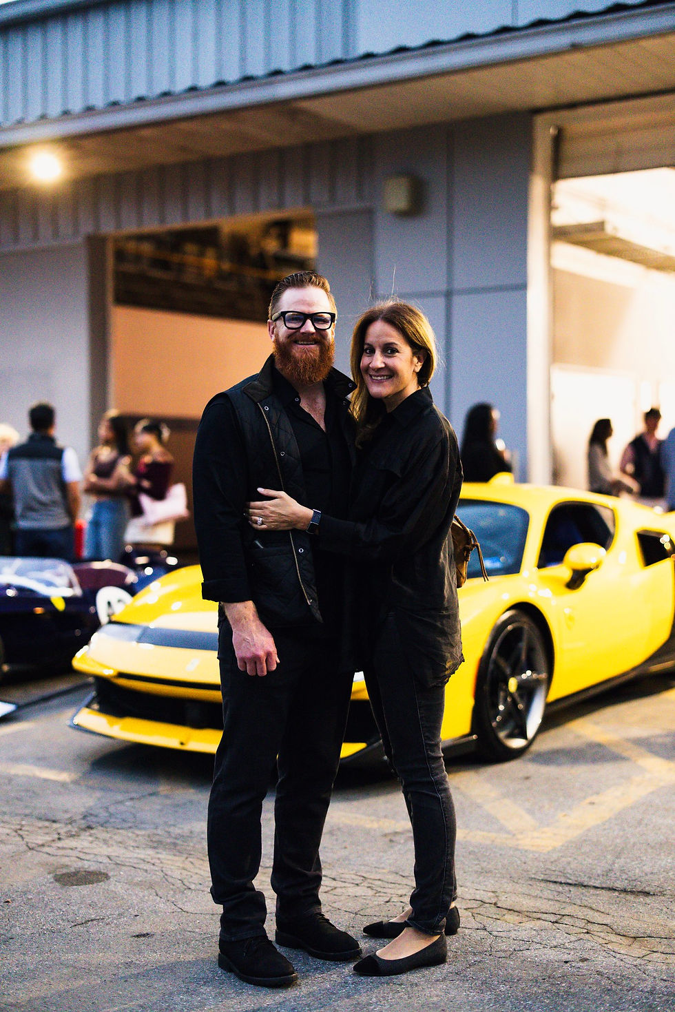 Patrick Novak and Amina in front of a yellow Ferrari F80 at Cars & Kidneys 2026.