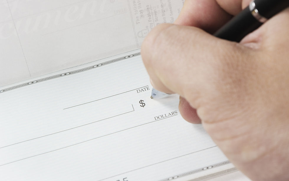 person writing a personal check