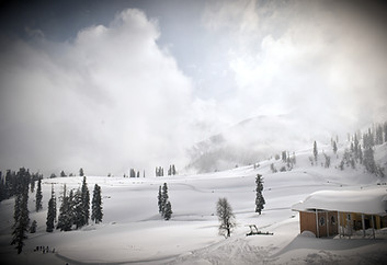 a snow covered mountain with a small cab