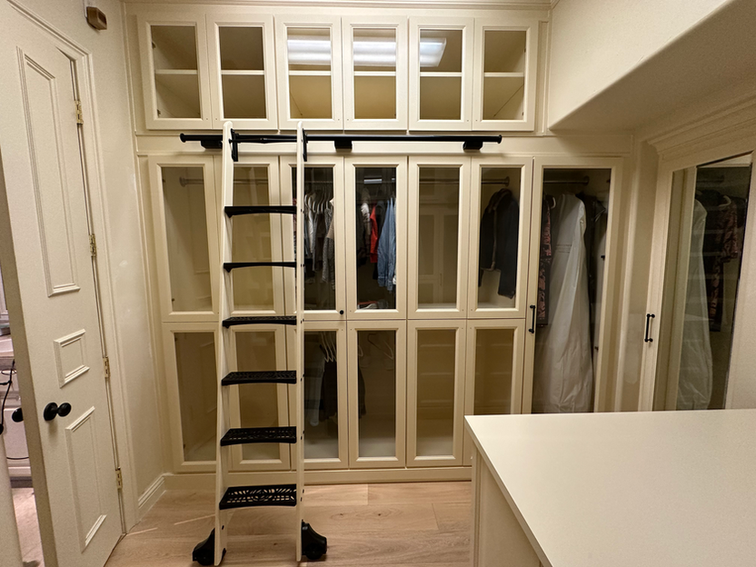 closet cabinets. closet built-in. glass door cabinet. rolling ladder system. closet island with 12 drawers. deep drawers.
