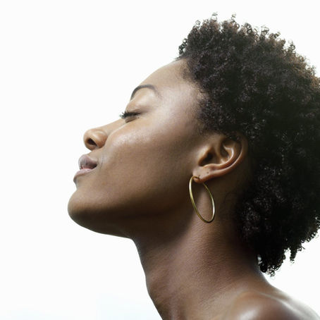 profile of black woman with tightly coiled short 4c natural hair