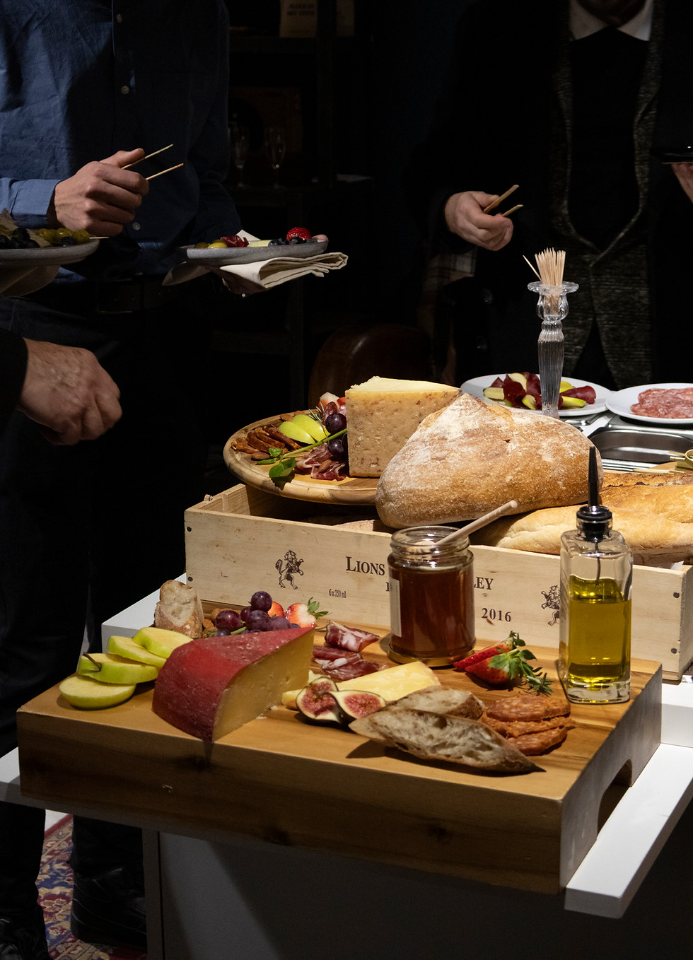 Guests enjoying our signature charcuterie cart at a private tasting