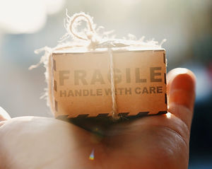 Hand holding fragile box