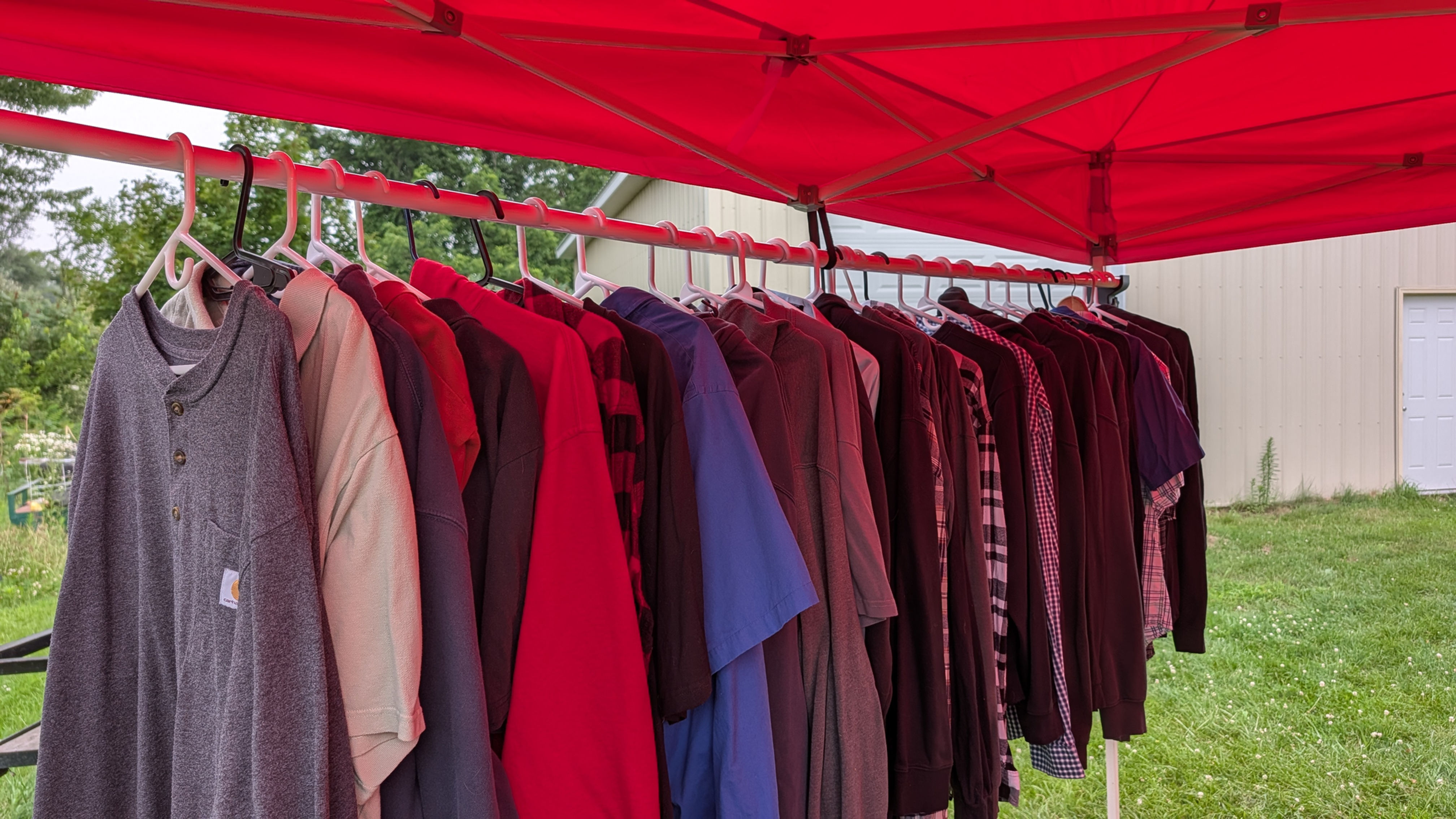 TentGrip Booth Beam canopy clothing display mount holding apparel inside a vendor tent