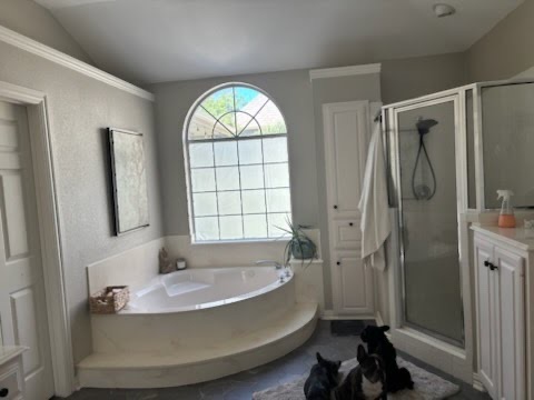 Dated corner deck tub structure and enclosed metal-framed glass shower stall before high-end modern spa bathroom renovation in the DFW area.