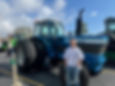 Blaze Fehr poses in front of a Ford TW-30 Friday during Prairie Central FFA Day in Fairbury.