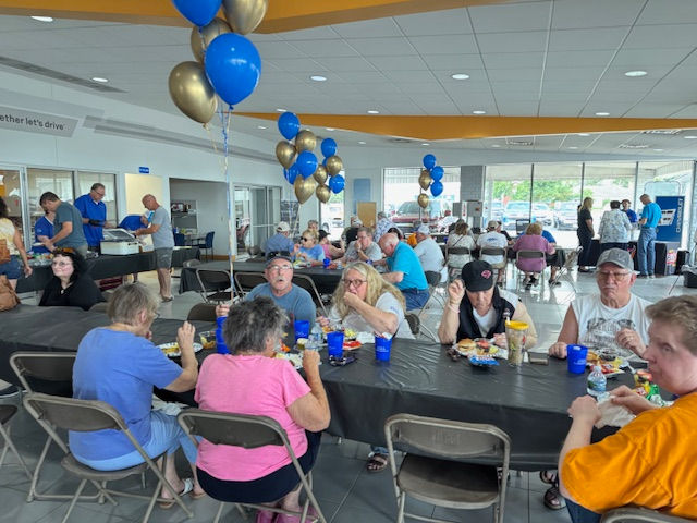 Visitors fill the showroom Friday at Petersen Chevrolet in Fairbury.
