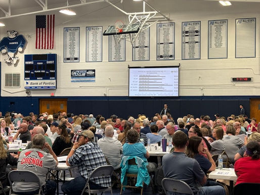 Crowd votes on school plan