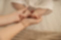 Mother gently holding baby’s feet, representing connection and care.