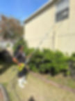 A man pressure washing the house window and walls