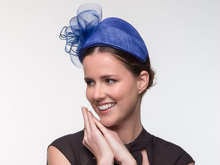 Structured blue bandeau headpiece with a refined silhouette, styled for special occasions with understated elegance.