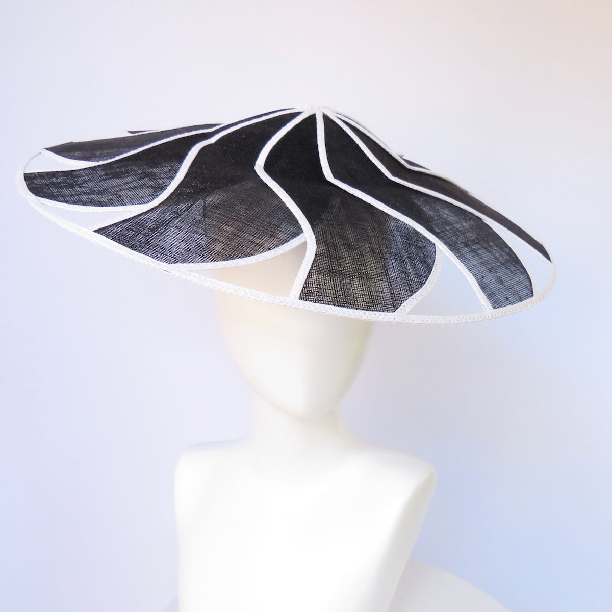 Black and white geometric brim headpiece by Melbourne milliner Catherine Storm, handcrafted in sinamay and Swiss braid view 1