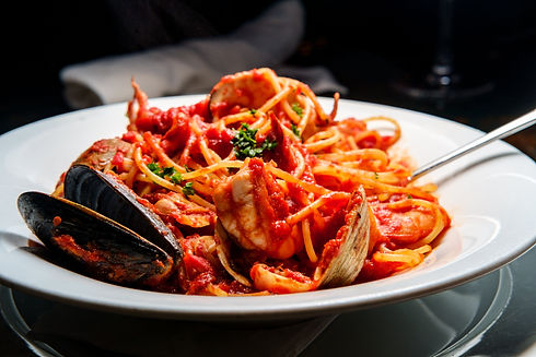 Frutti Di Mare: Made with littleneck clams, mussels, shrimp, fresh crabmeat and scallops in a light marinara sauce served over angel hair pasta.