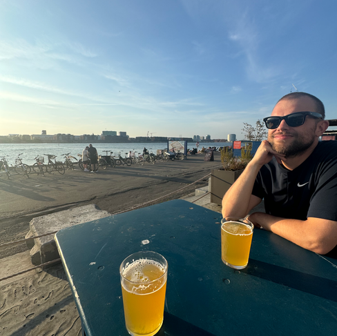 A man sitting at a table with two beers