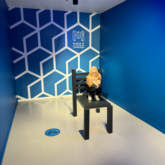A woman on a large chair with a blue background
