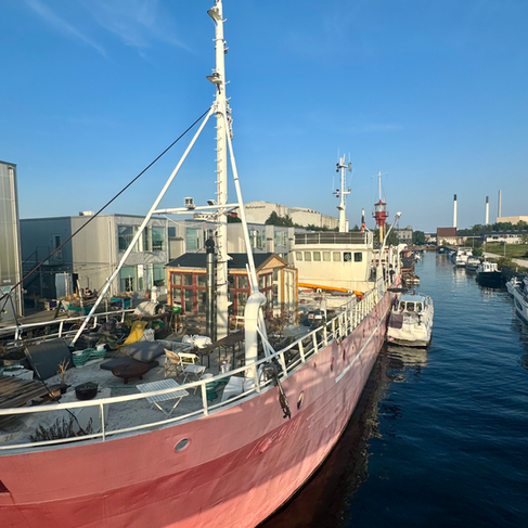 A large red boat on a canal