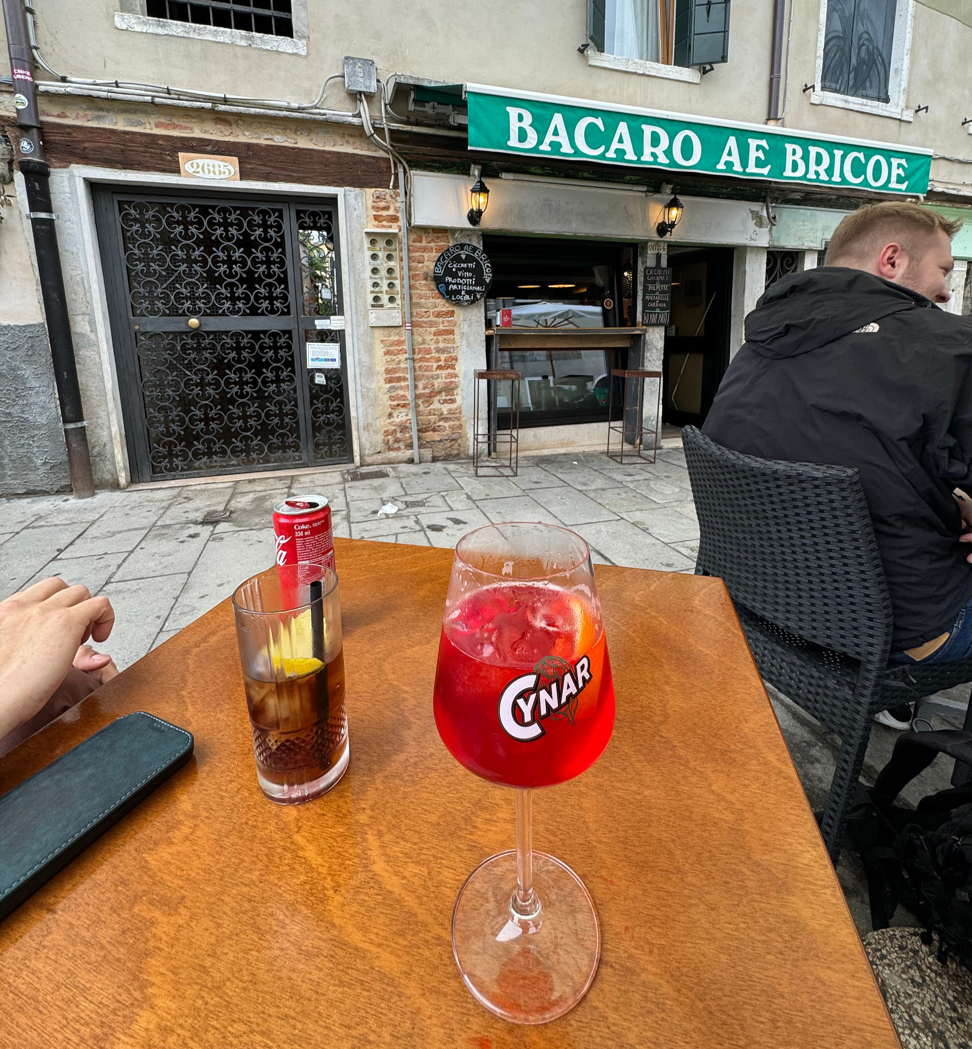 Having drinks at bar on Venice canal