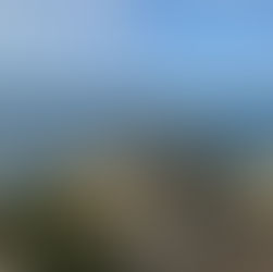 A woman walking along a cliff