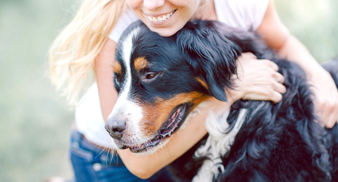 Woman Hugging Dog