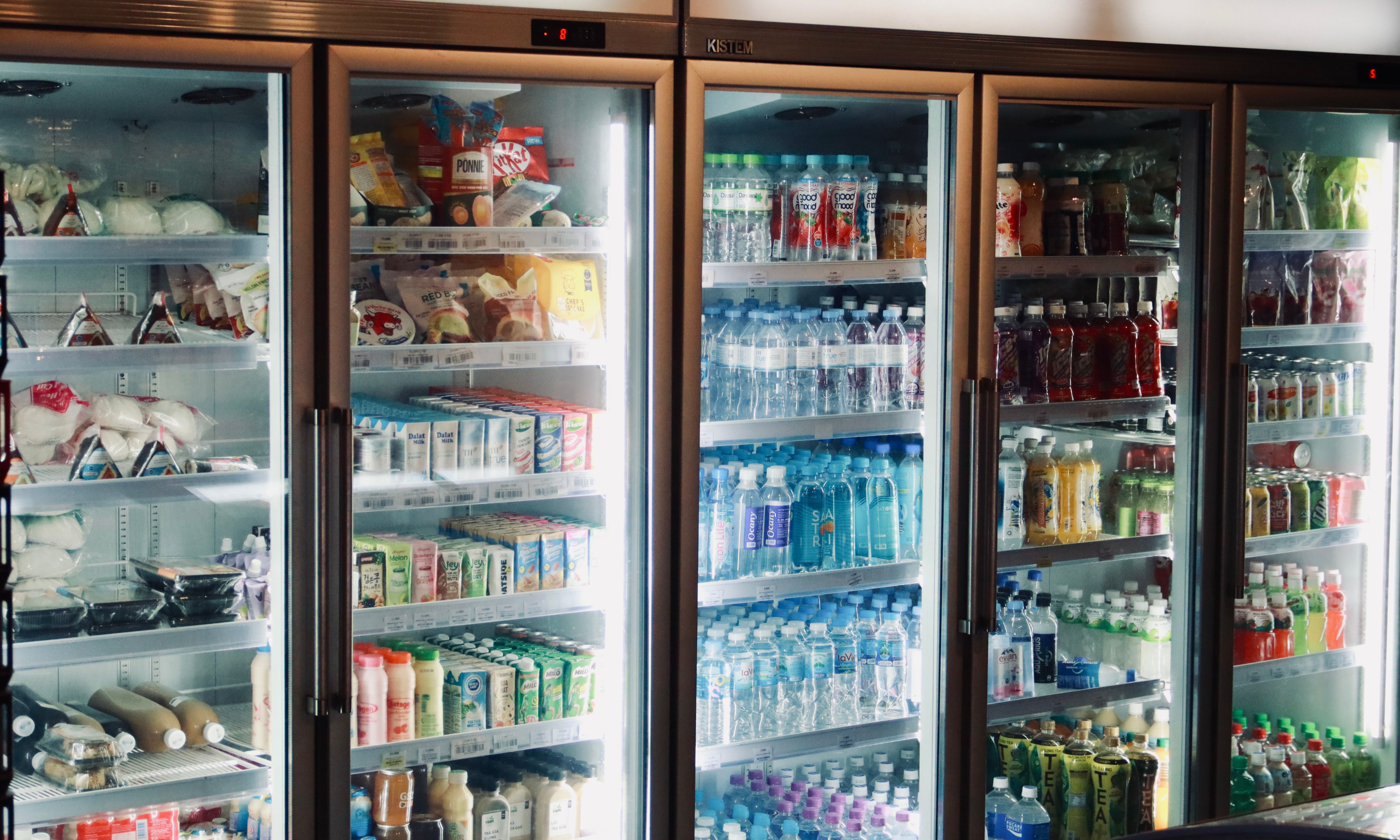 Glass-door commercial refrigerators stocked with beverages and chilled food