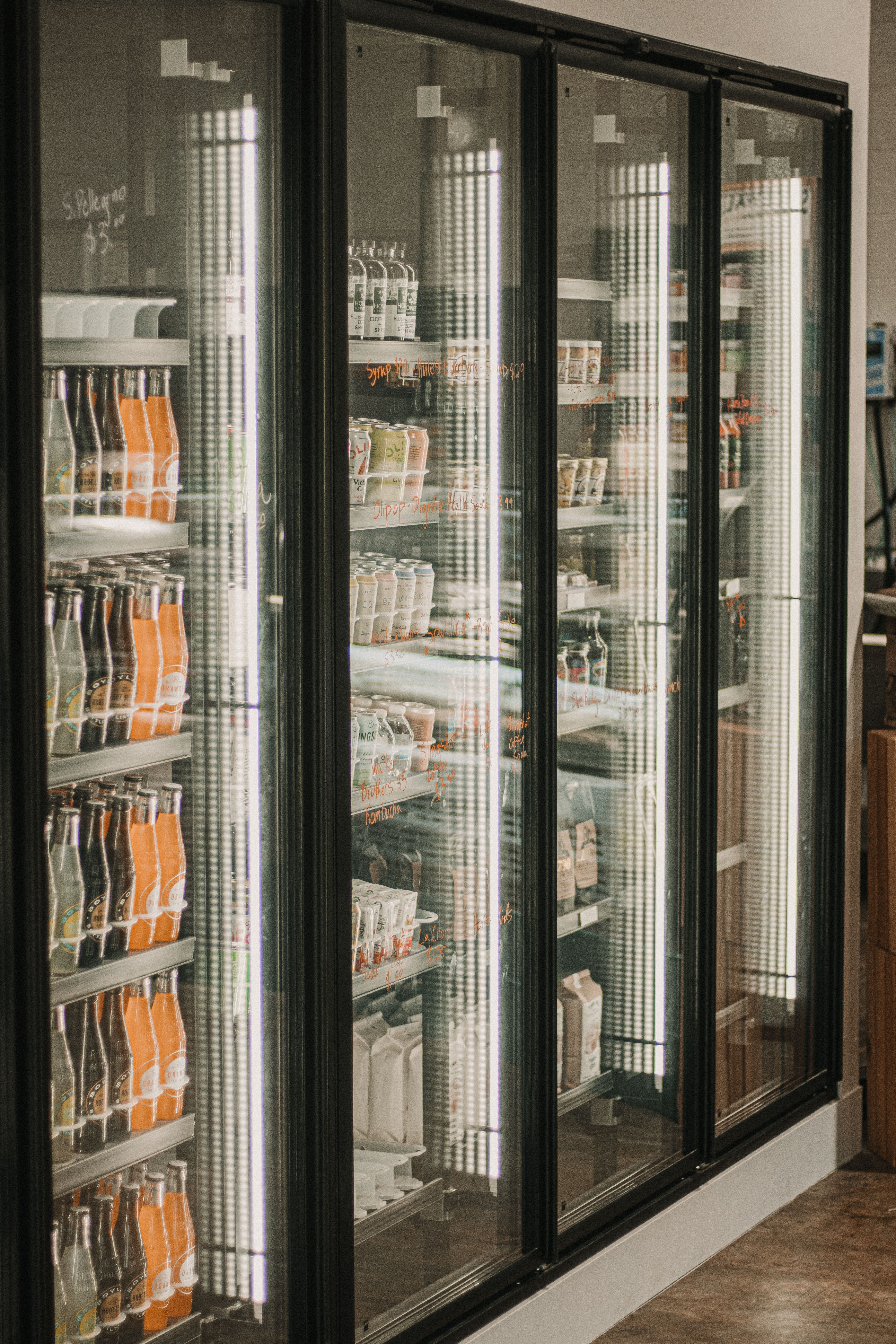 Commercial refrigerator display with glass doors and organized shelves