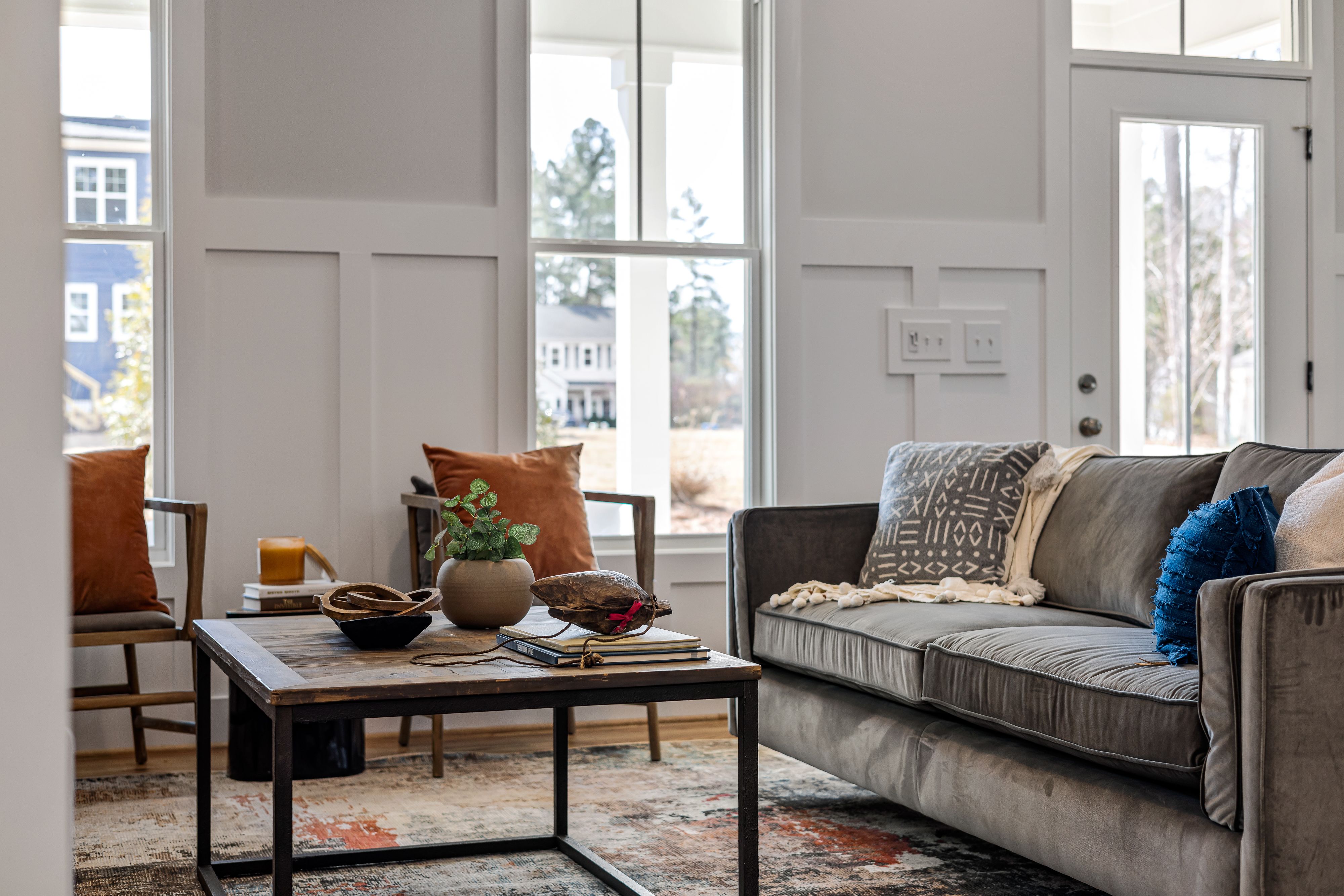 Elegant neutral living room with large windows