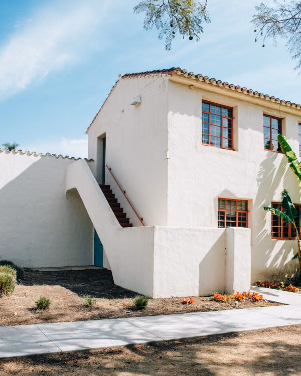 White stucco cottage with exterior steps