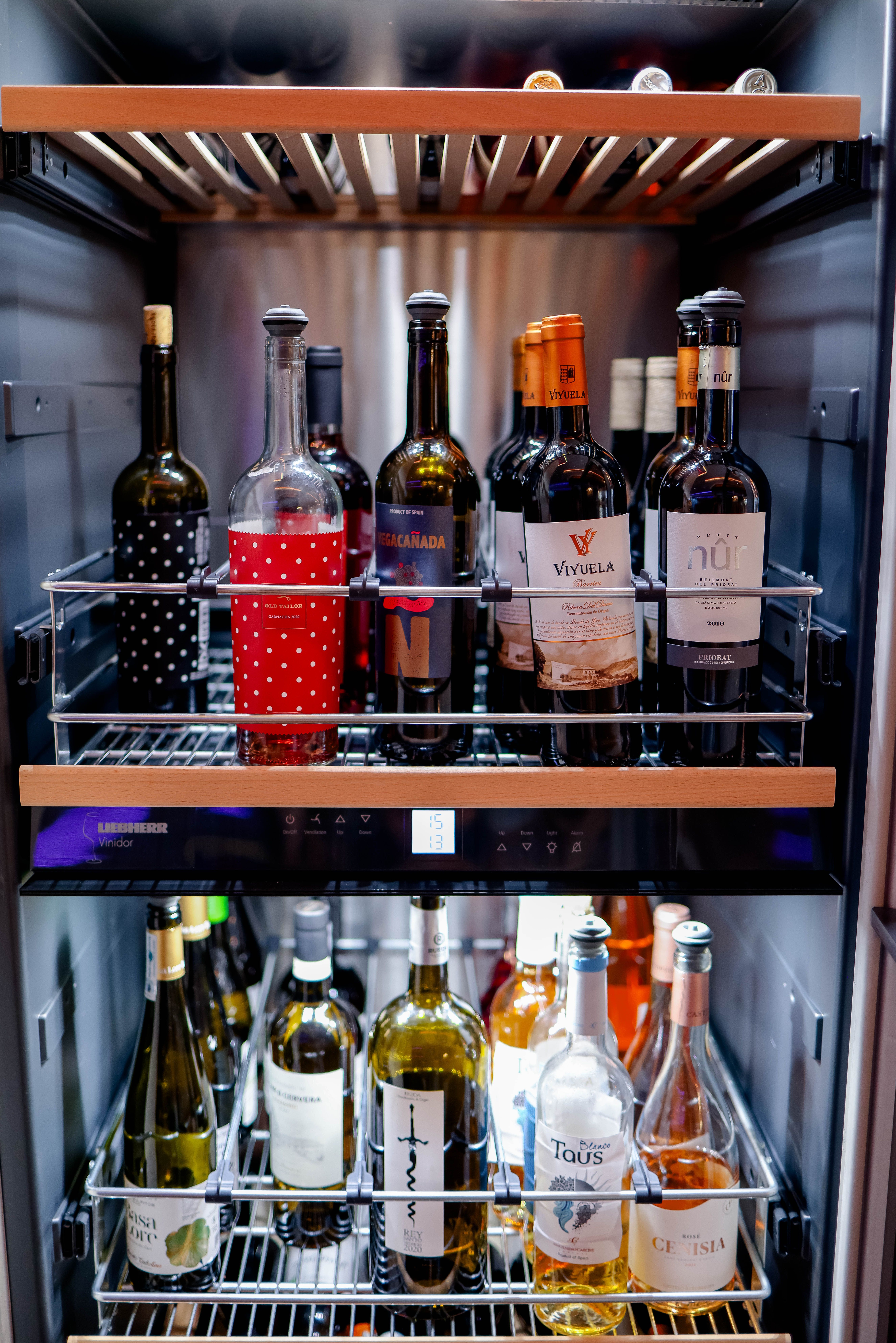 Wine bottles stored in a temperature-controlled wine refrigerator