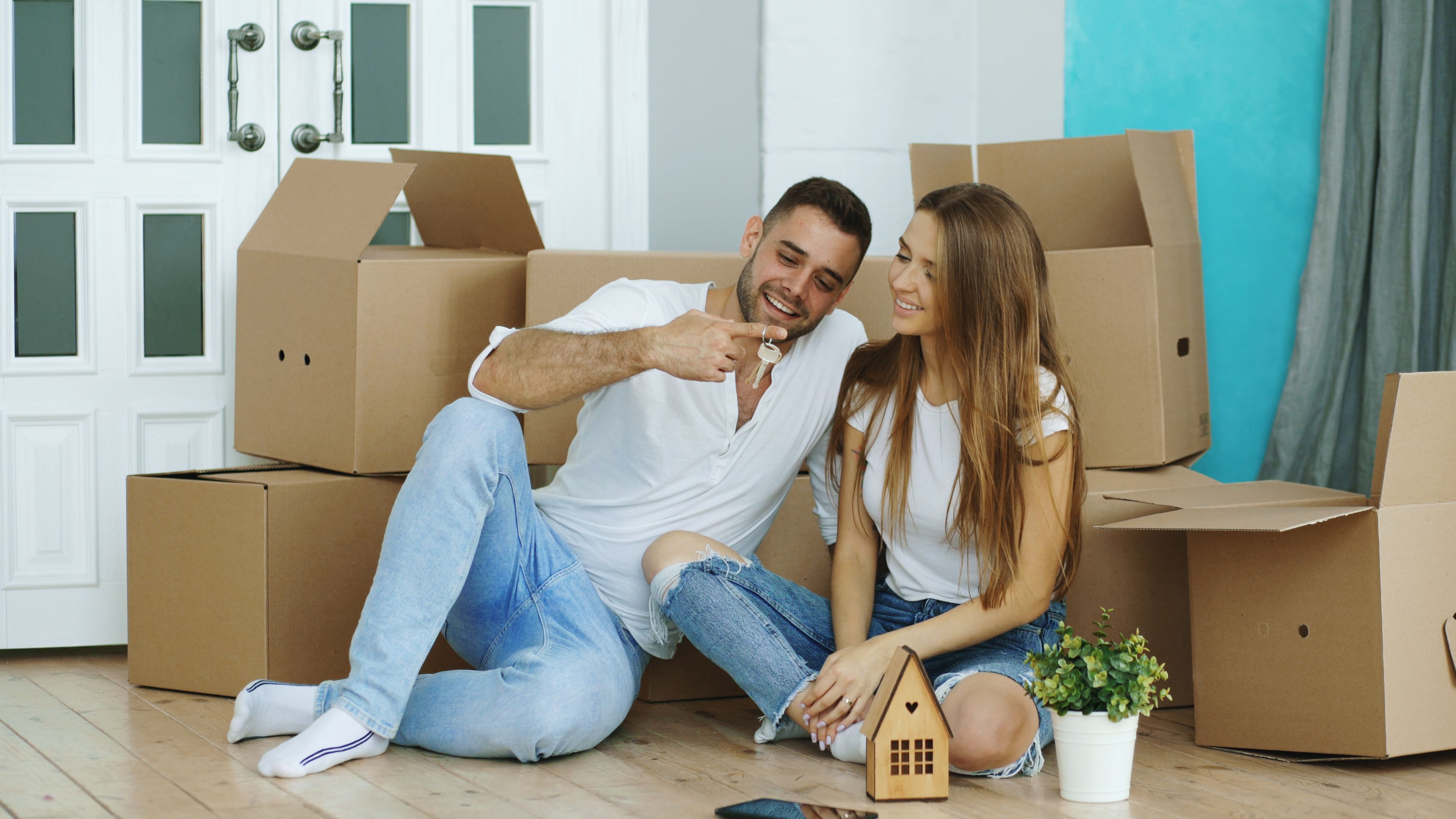 Couple celebrating a home purchase with moving boxes