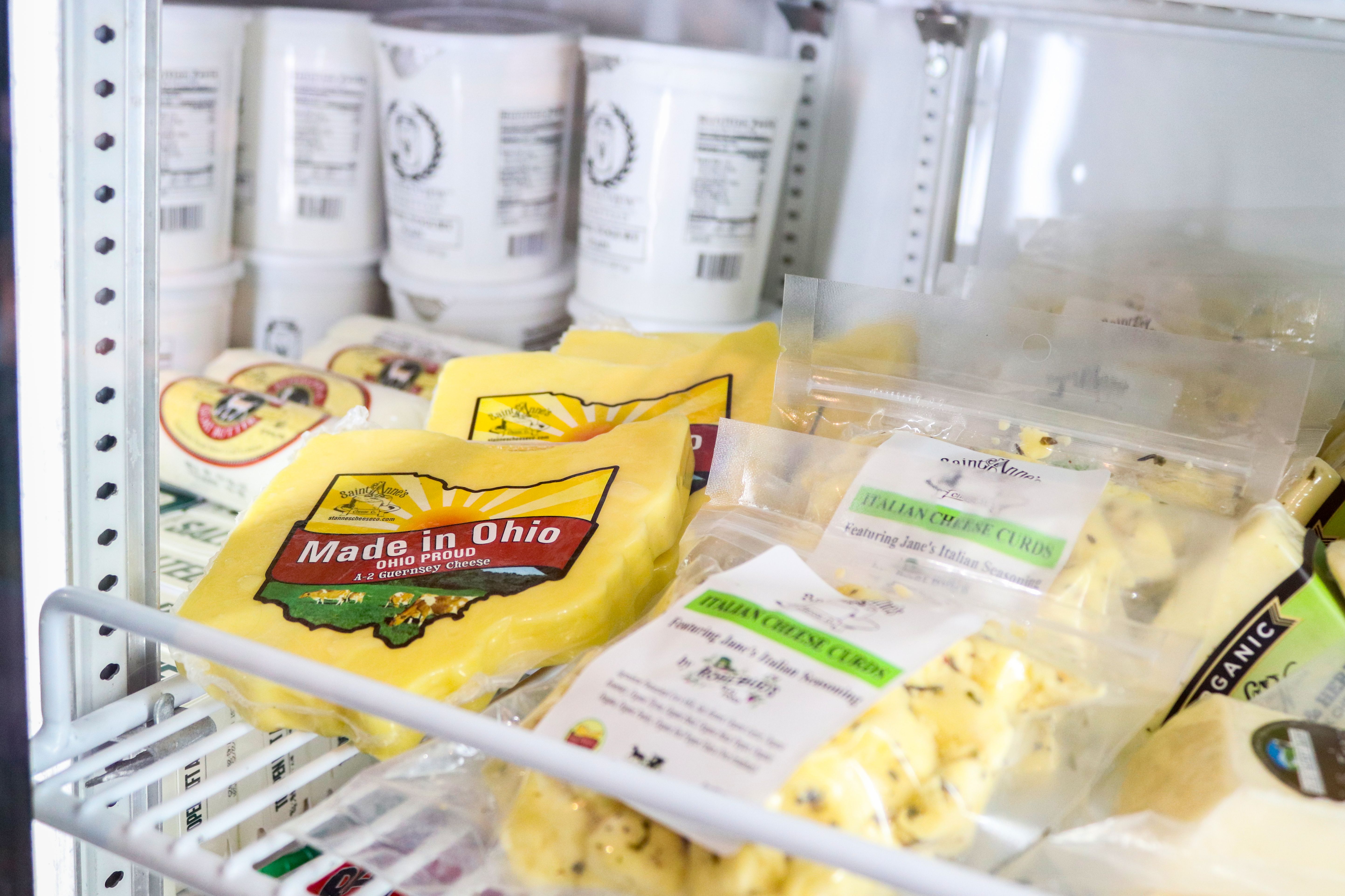 Packaged cheese on illuminated refrigerated display shelves