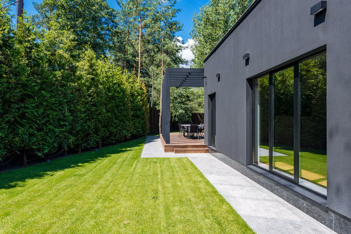 Modern house with a green lawn and outdoor seating