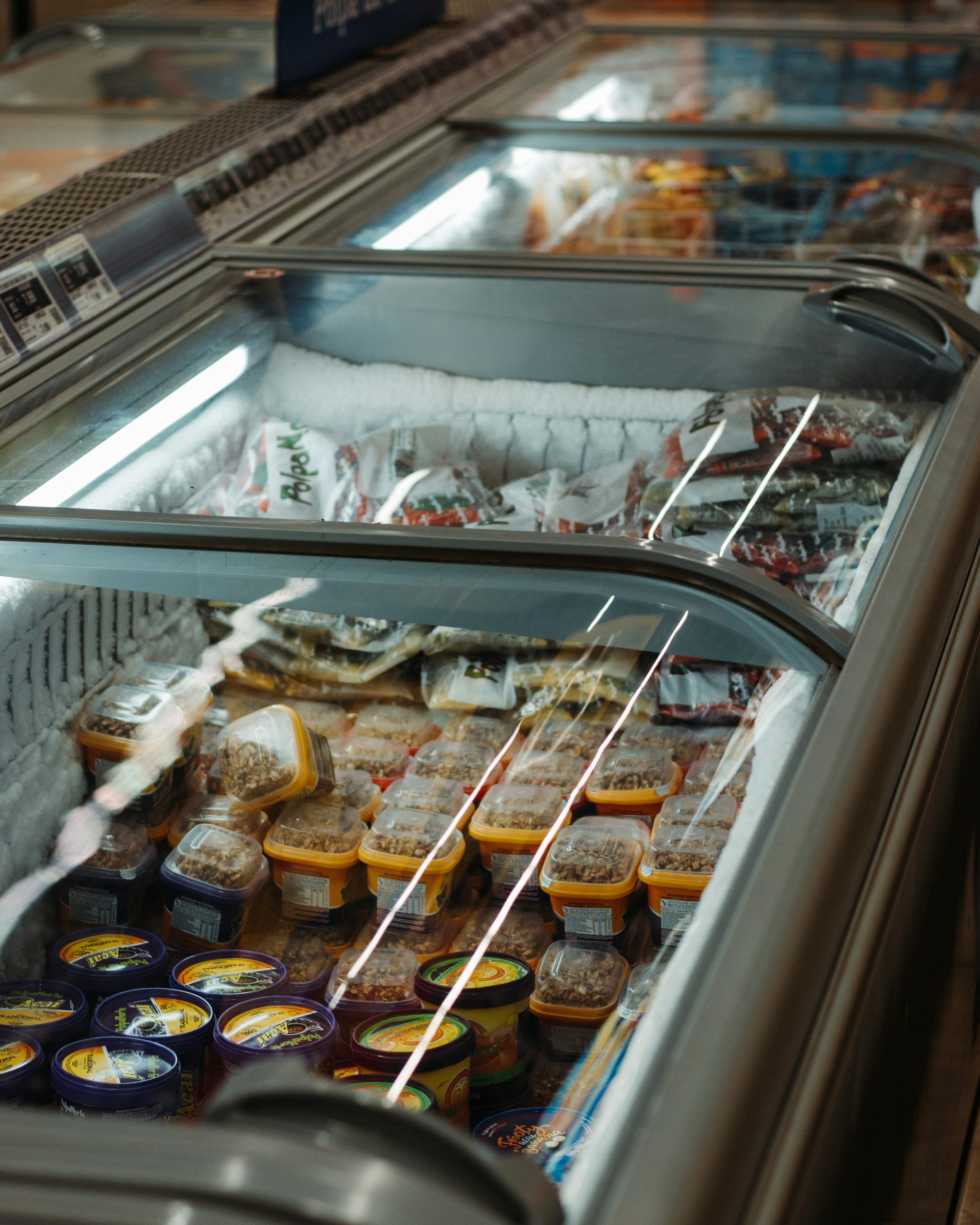 Commercial chest freezers stocked with frozen food