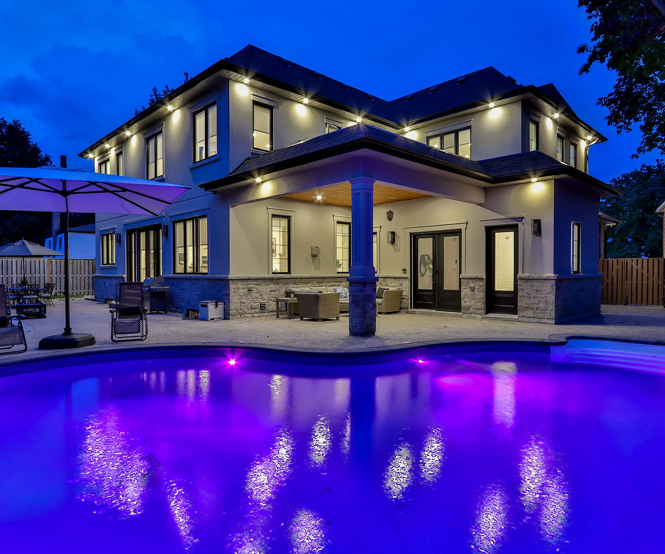 House exterior and backyard pool at dusk