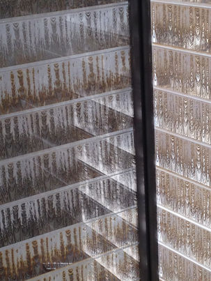 Room screen and free floating panels with aluminum frame, acrylic tiles with laser cut feather-like pear necklace layered pattern and design
Burnt paper edges have hues of amber, brown, and black.  