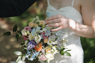 bride holder her bouquet with local flowers