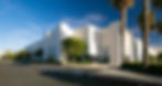Modern white office building with palm trees and blue sky