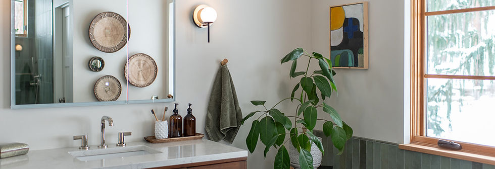 A modern bathroom featuring handmade green tile.