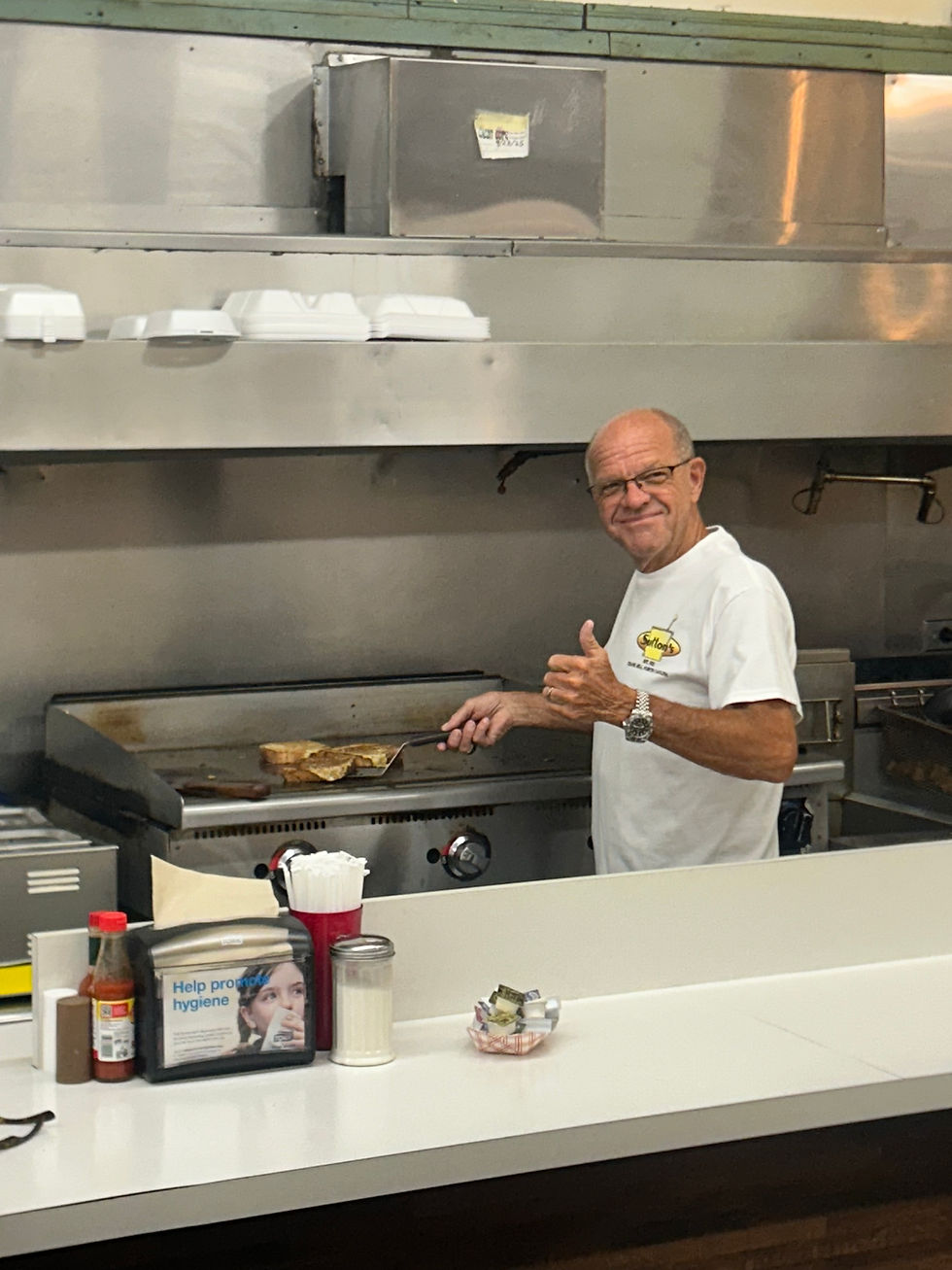 Sherriff Blackwood works the grill at Suttons during Coffee with a Cop