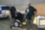 Two deputies cook on gas grill for senior picnic