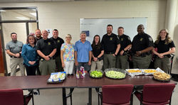 Deputies flank couple who prepared an appreciation lunch for them
