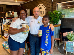 sheriff poses with woman and child at social event