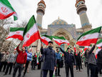 Protesters gather with Iranian national flags during a demonstration in support of the government and against US and Israeli strikes outside a mosque in Tehran, Iran. (Photo: AFP)