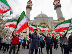 Protesters gather with Iranian national flags during a demonstration in support of the government and against US and Israeli strikes outside a mosque in Tehran, Iran. (Photo: AFP)